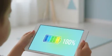 Child holding tablet with full battery indicator