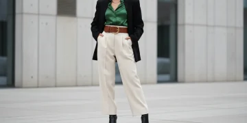 Fashion model wearing high-waisted trousers with fitted blouse demonstrating perfect outfit proportions